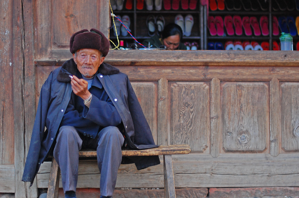 An old man sitting on the bench. Image Credit: Flickr / timquijano