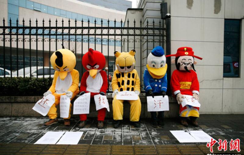 Migrant workers in Beijing dressed in cartoon costumes to protest unpaid wages